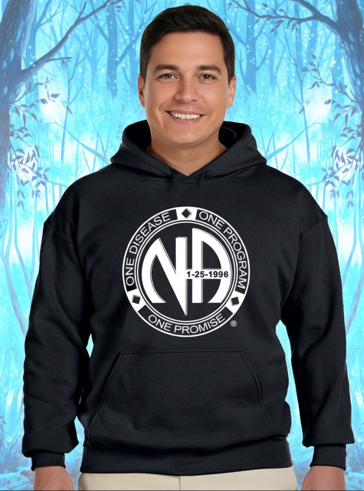 A person wearing a black pullover hoodie with a large white circular graphic on the chest reading 'ONE DISEASE ONE PROGRAM ONE PROMISE 1-25-1996' and featuring stylized letters 'ND'. The background is a bright blue, icy forest pattern.