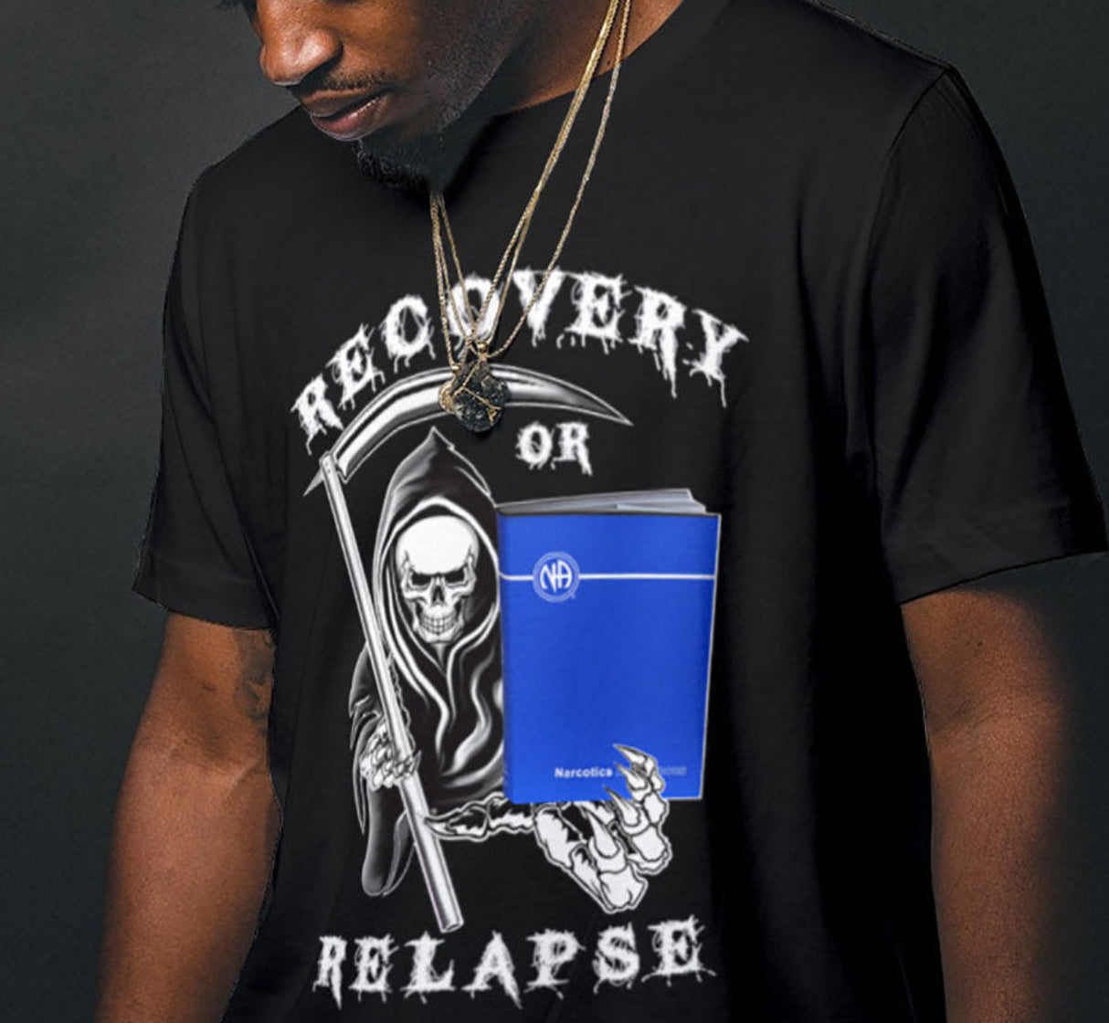 A man wearing a black crew neck T-shirt with 'RECOVERY OR RELAPSE REAPER' text and graphic design in white.