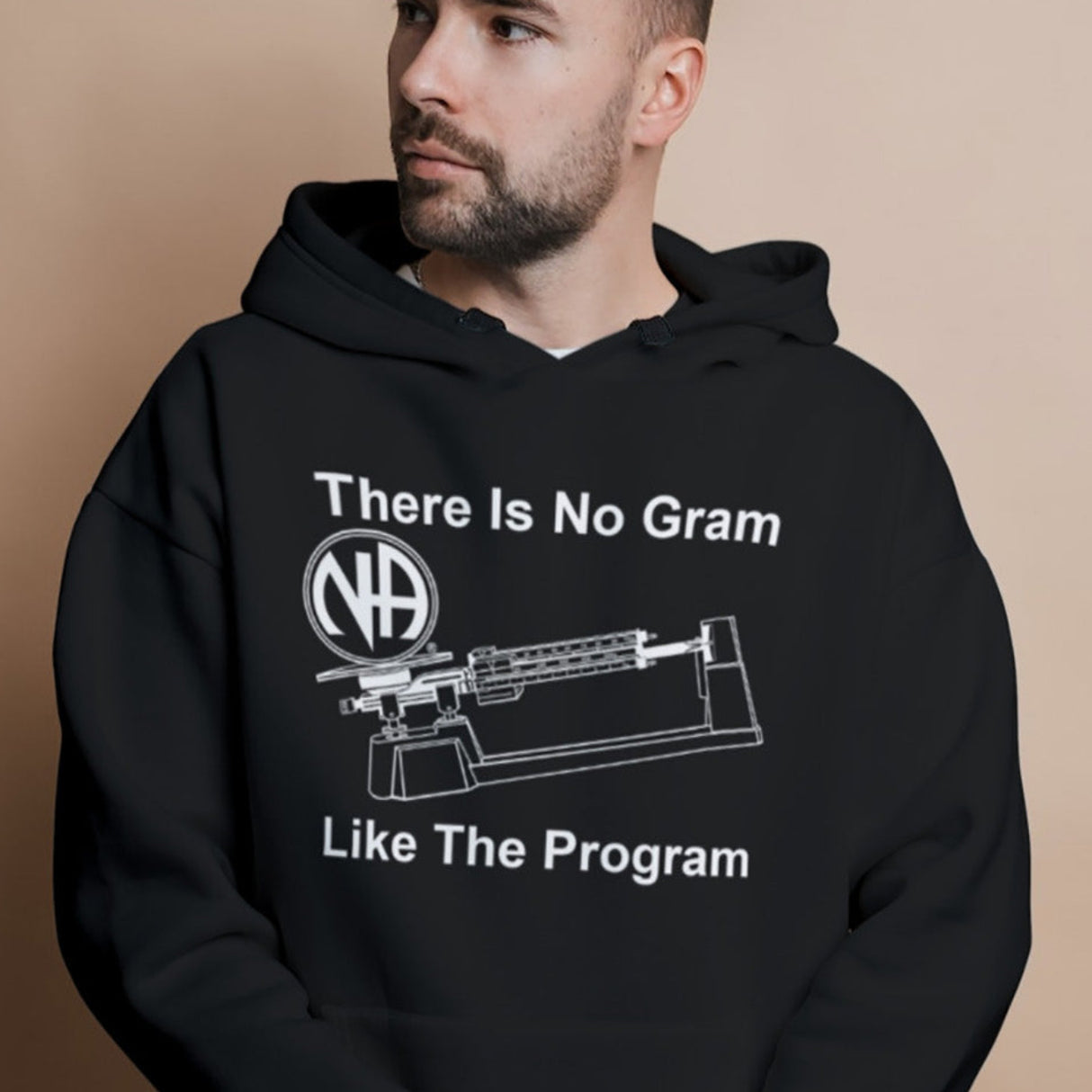 A person wearing a black hoodie with text and graphic design on the front.