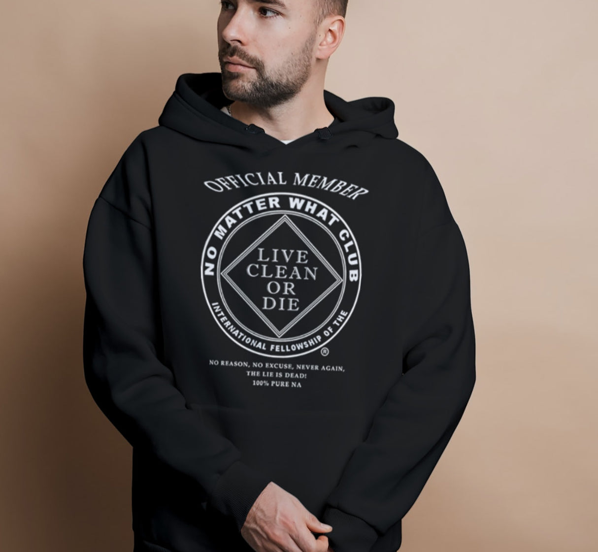 A male model wearing a black hoodie with white text and graphic on the front, featuring a double-lined hood, ribbed cuffs, and a pouch pocket.