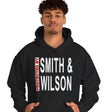 Person wearing a black hoodie with 'Smith & Wilson' text on a white background