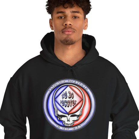 Person wearing a black hoodie with a colorful logo on a white background