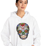 Person wearing a white hoodie with a colorful skull design on a white background