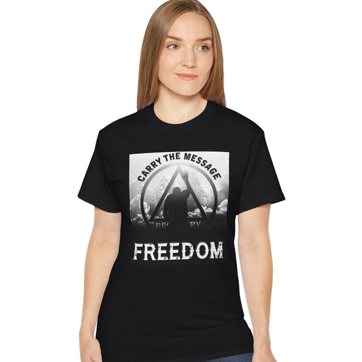 Person wearing a black t-shirt with 'Carry the Message Freedom' design on a white background
