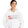 Person wearing a white hoodie with 'BELIEVE IN YOURSELF' text on a white background