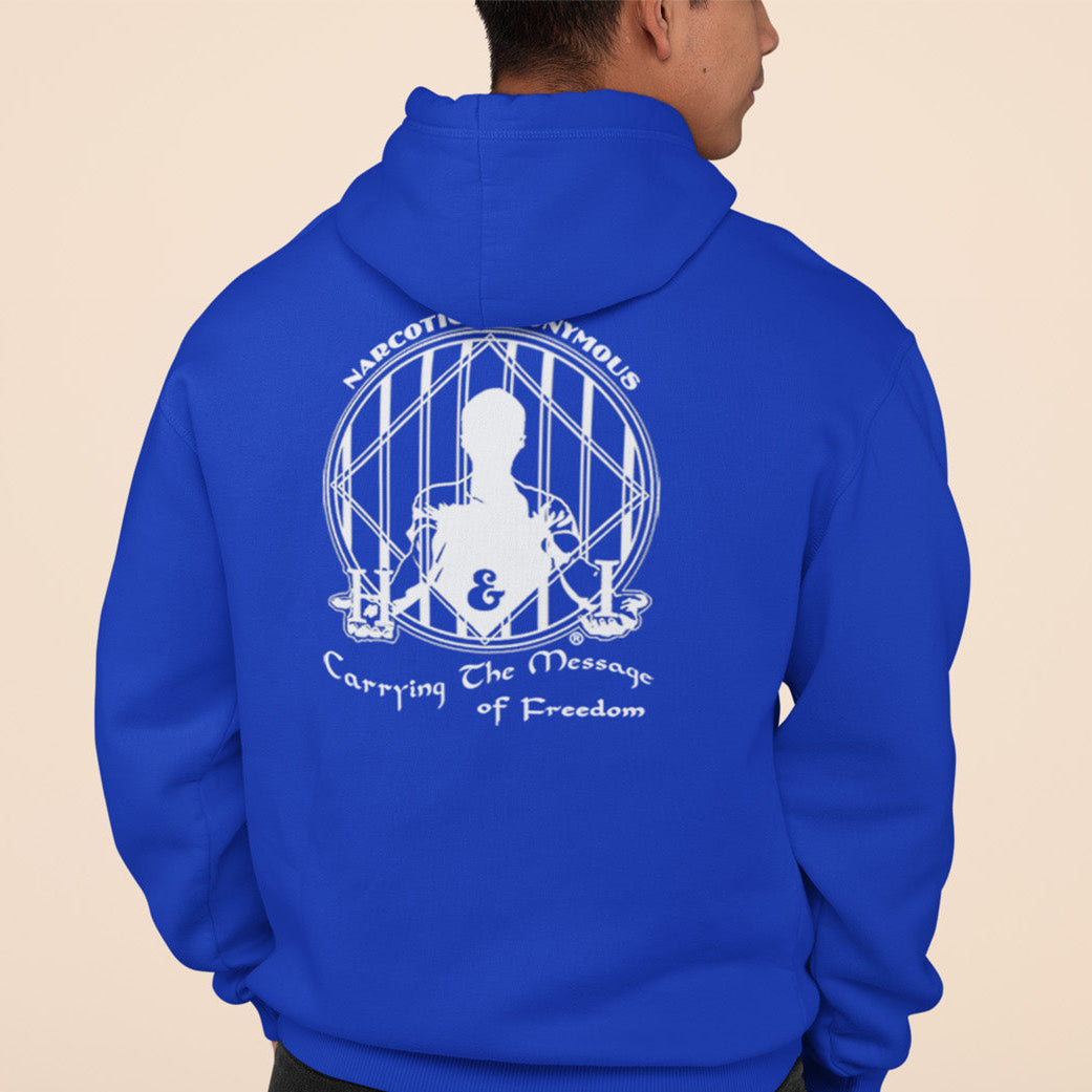 Person wearing a blue hoodie with a white graphic and text on the back against a beige background