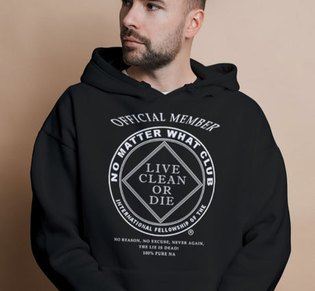 Man wearing a black hoodie with text on a beige background