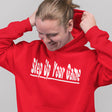 Person wearing a red hoodie with 'Step Up Your Game' text on a gray background