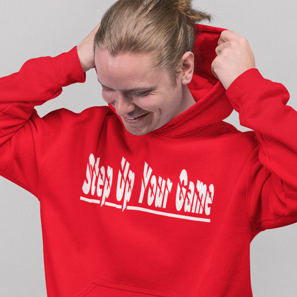 Person wearing a red hoodie with 'Step Up Your Game' text on a gray background