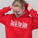 Person wearing a red hoodie with 'Step Up Your Game' text on a gray background