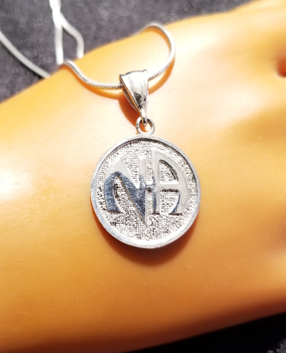 ssj003- Nickel Size NA Symbol Pendant